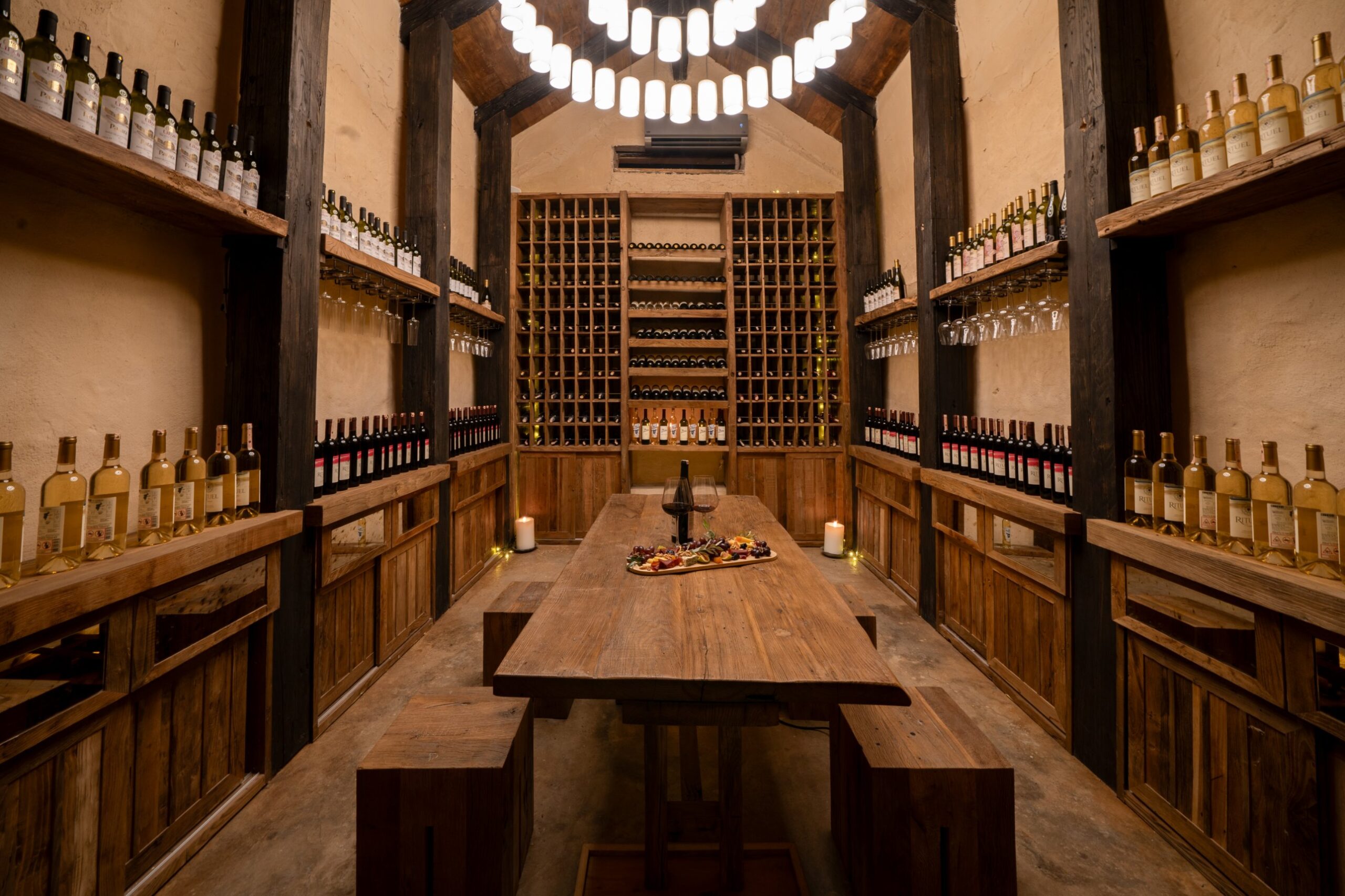 The venue's own wine cellar, racks of bottles either side of a long tasting table